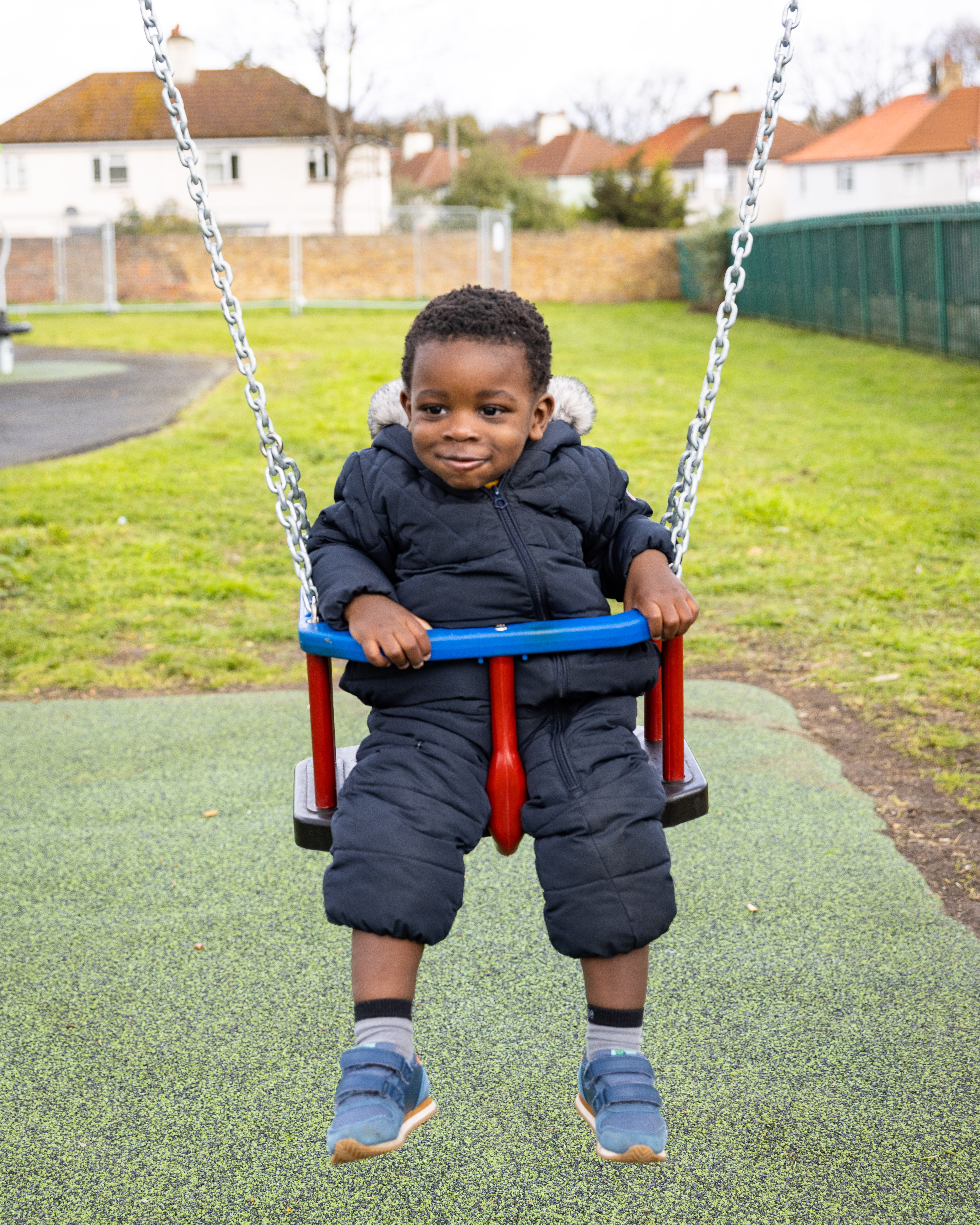 A little boy on a swing