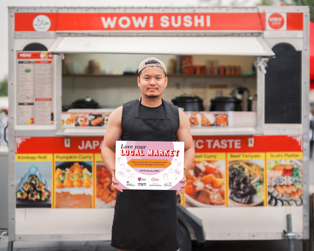 Wow! Sushi market stall holding sign that says Love Your Local Market