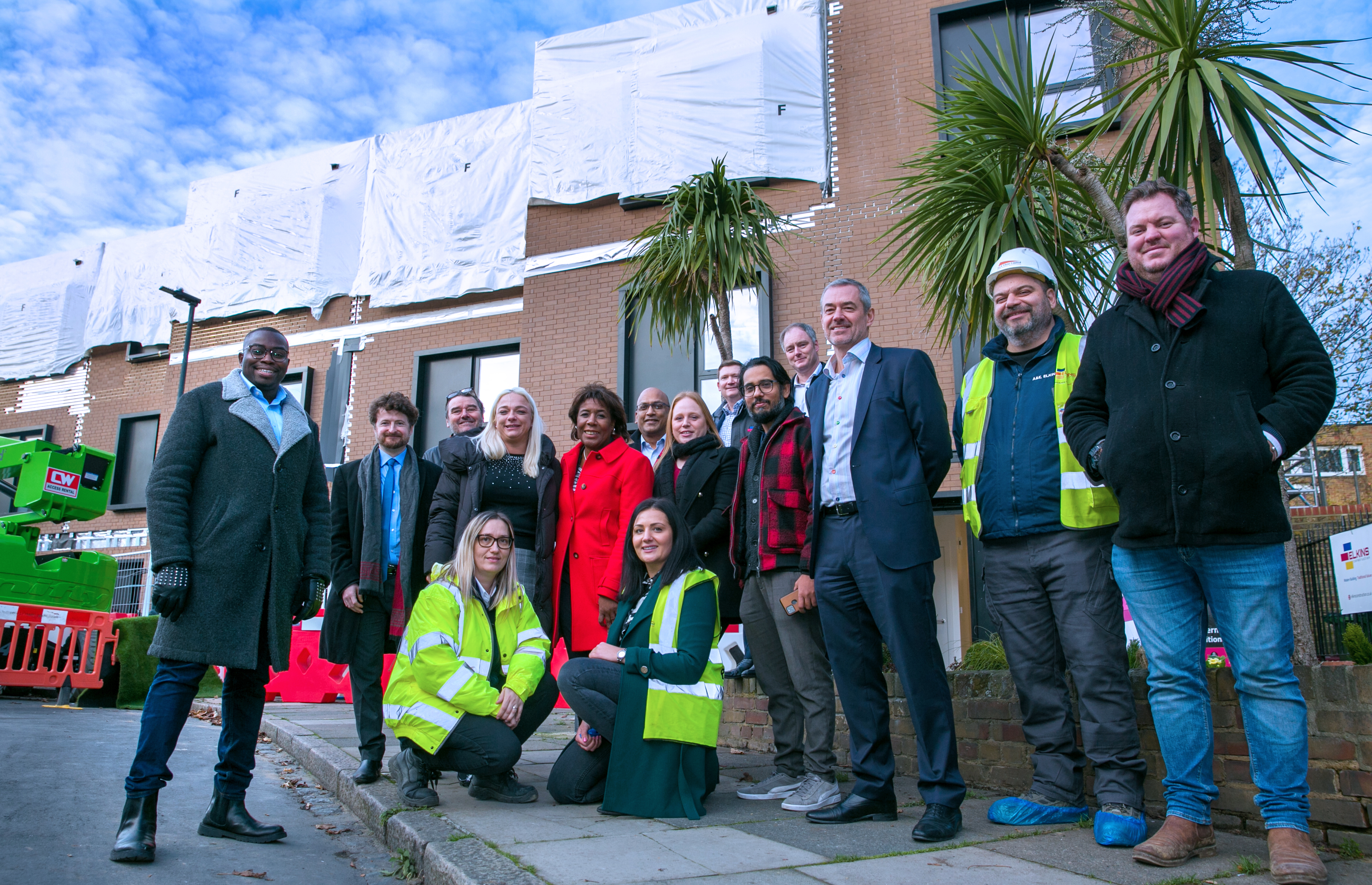 A group of councillors and contractors post outside a newbuild council home