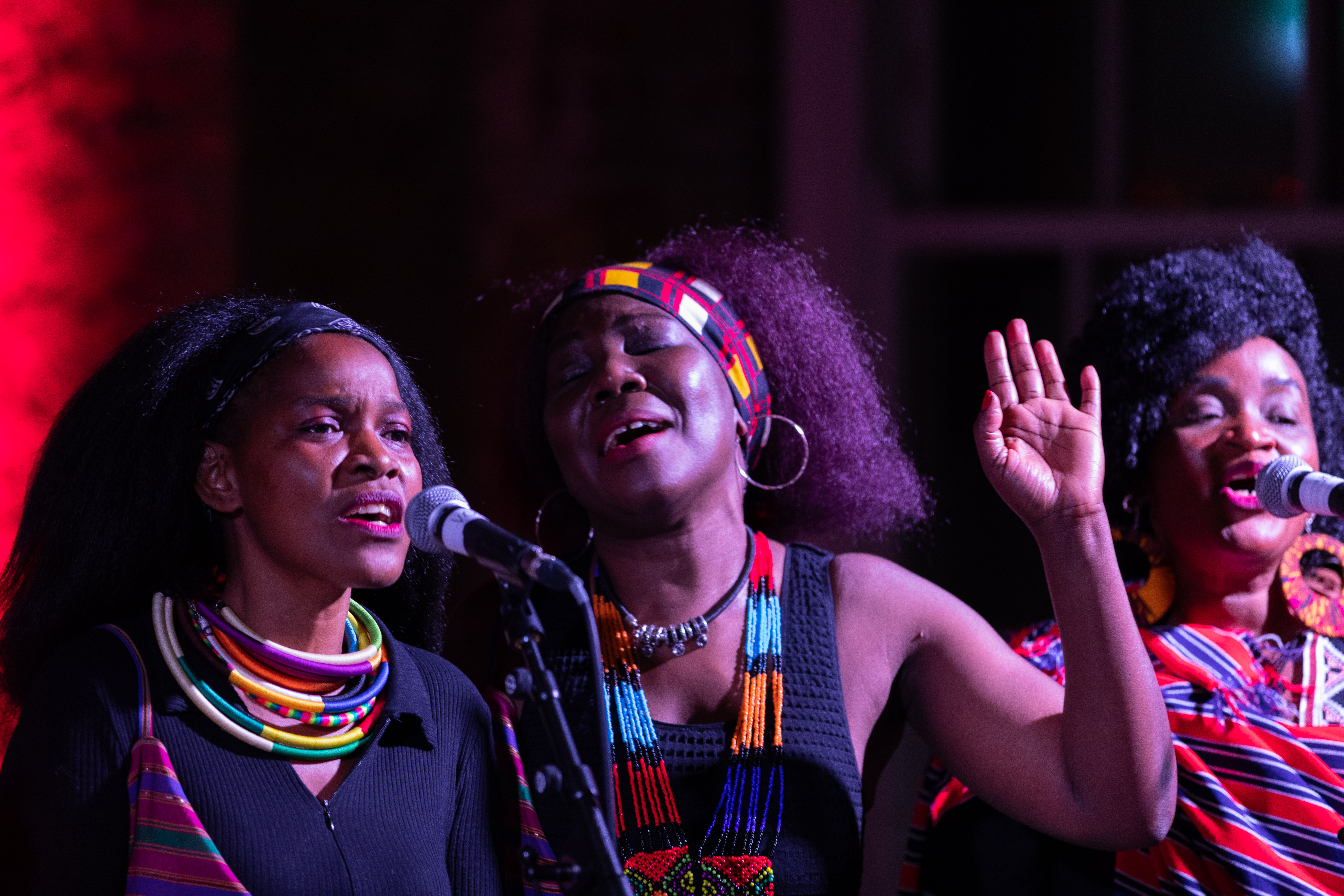 upclose shot of three female singers performing