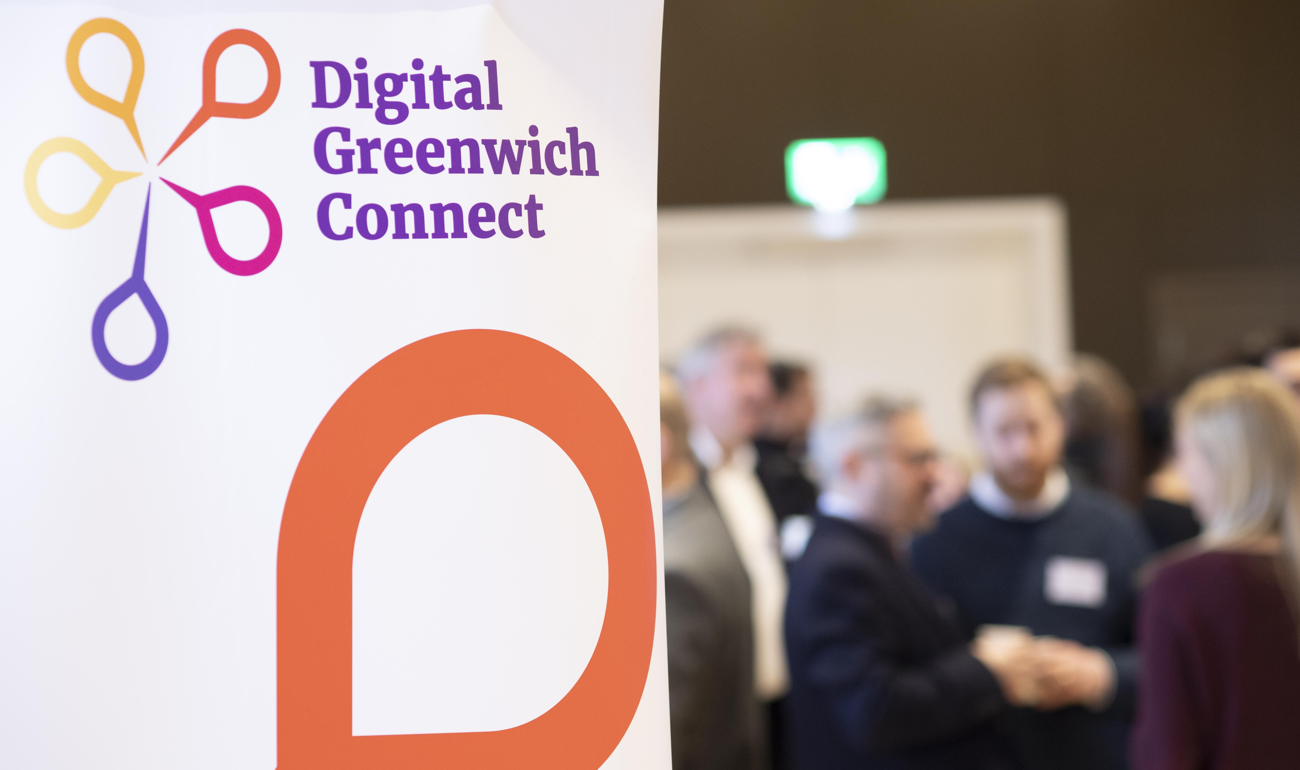 Photograph of a pull up banner which reads: Digital Greenwich Connects, against a blurred background of people attending a launch event