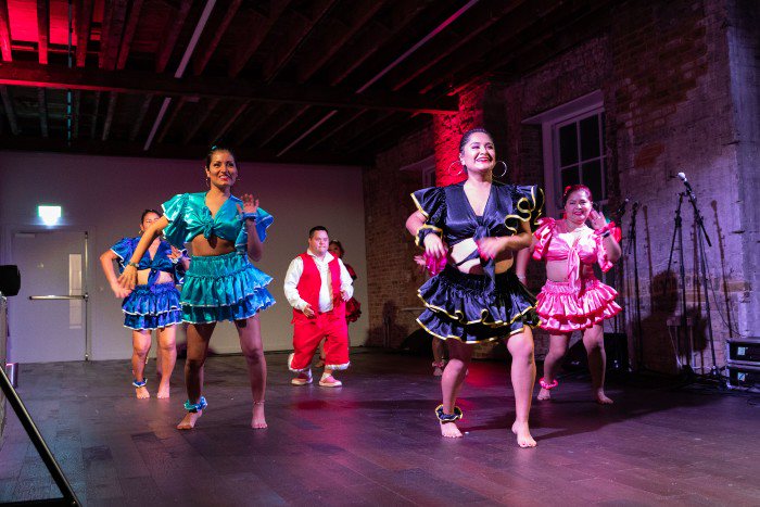 Five dancers in traditional Spanish clothing