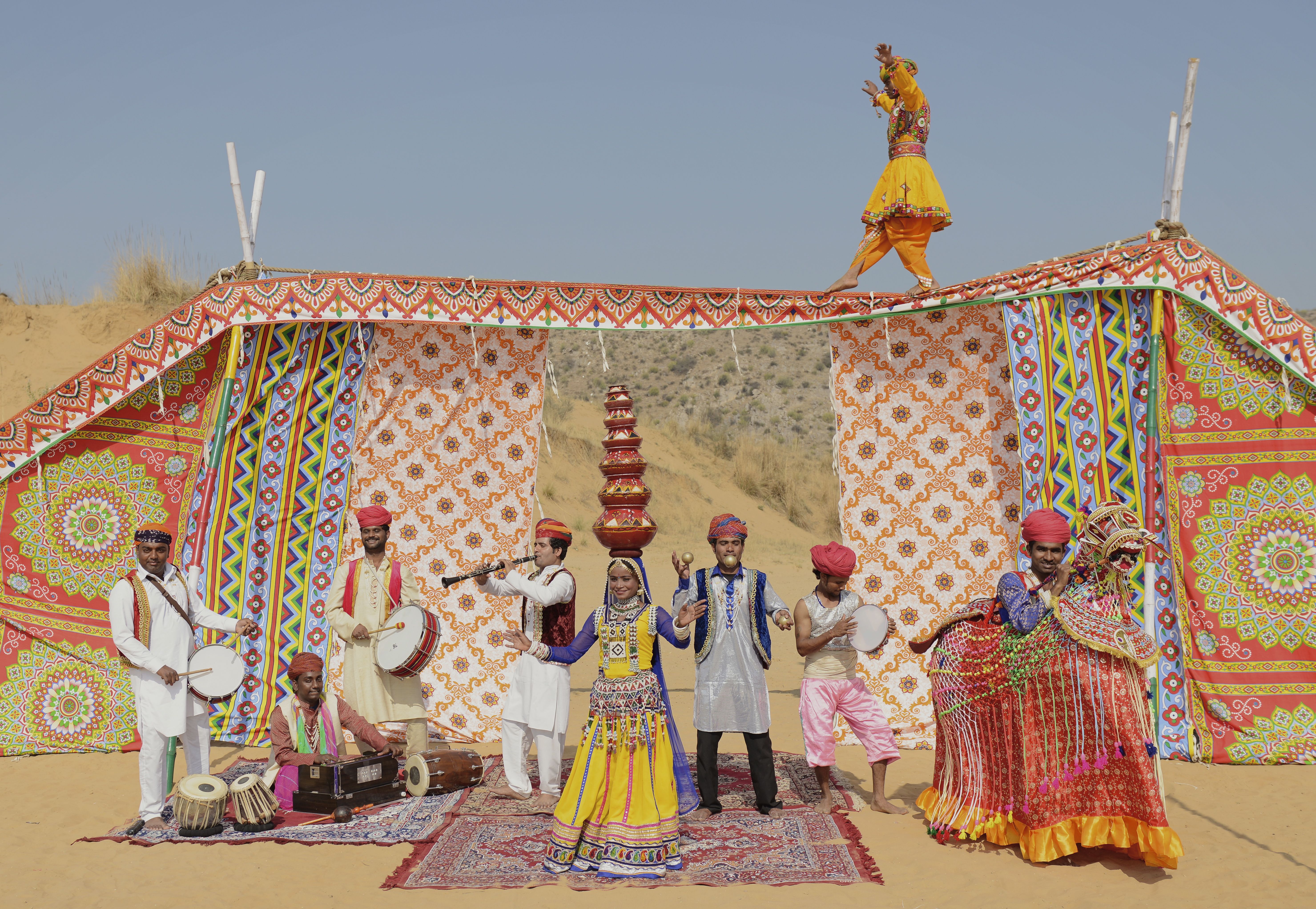 Musical perfomers under a tent in the desert