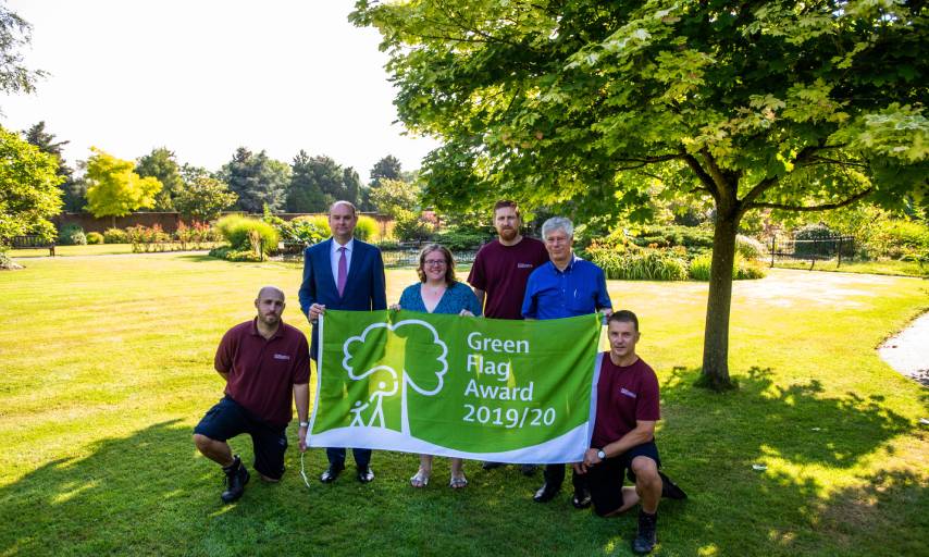 Councillors and grounds staff holding the green flag