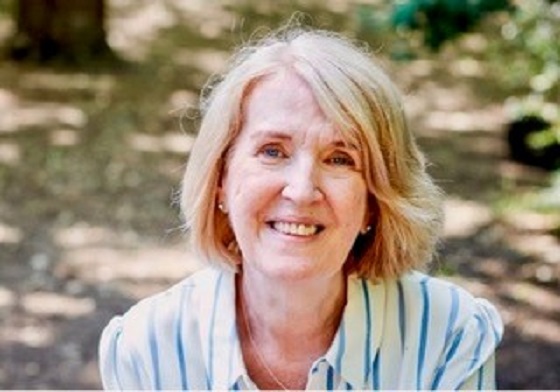 Dr Miriam Donaghy smiling at the camera in striped shirt