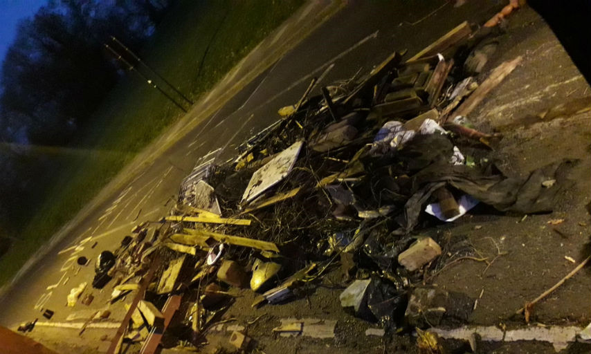 Fly-tipped rubbish littering the road.