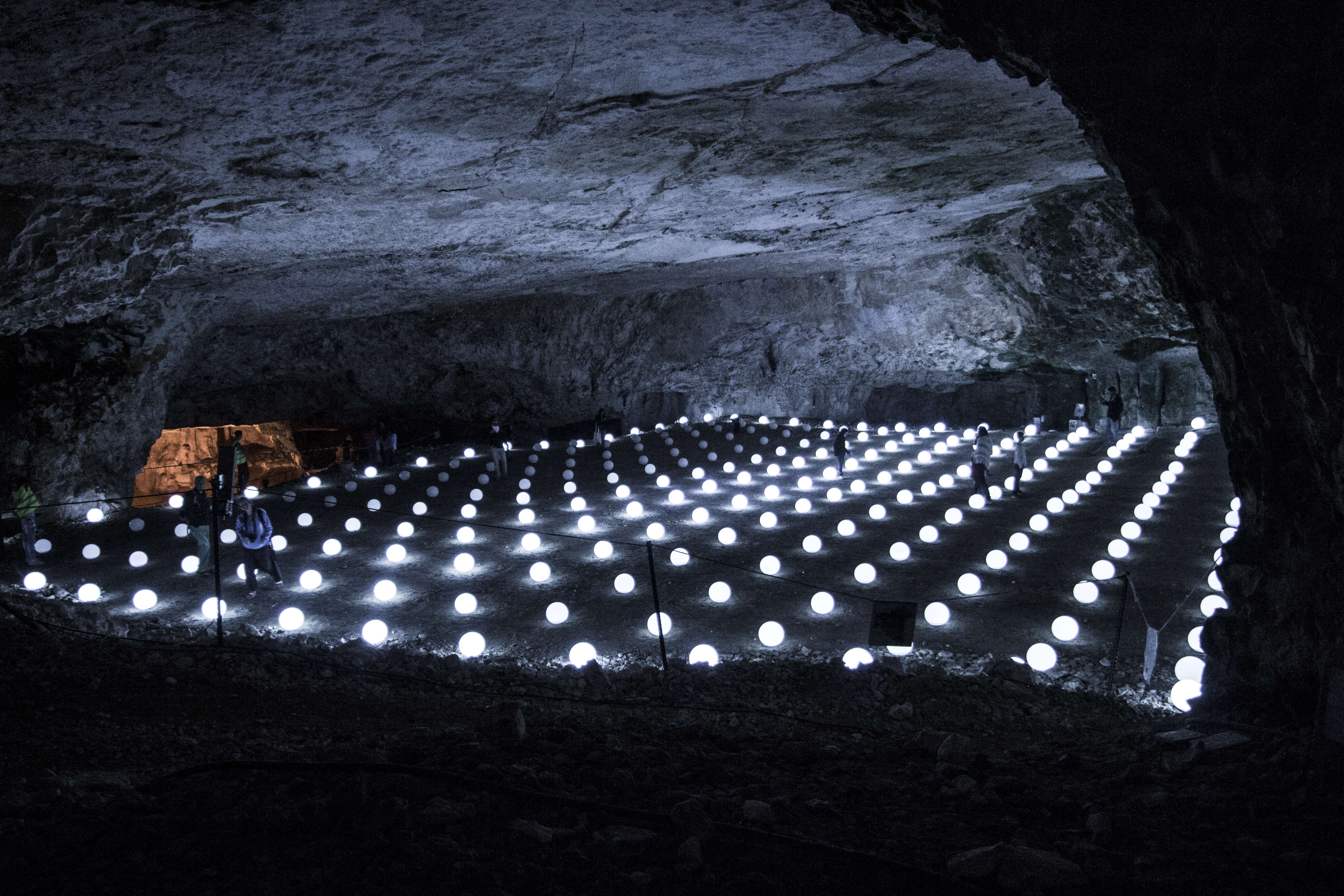 Globoscope light in jerusalem. Uniformed rows of light up spheres in a cave like environment.