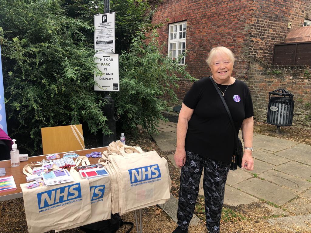 Linda community champion volunteer at NHS vaccine event