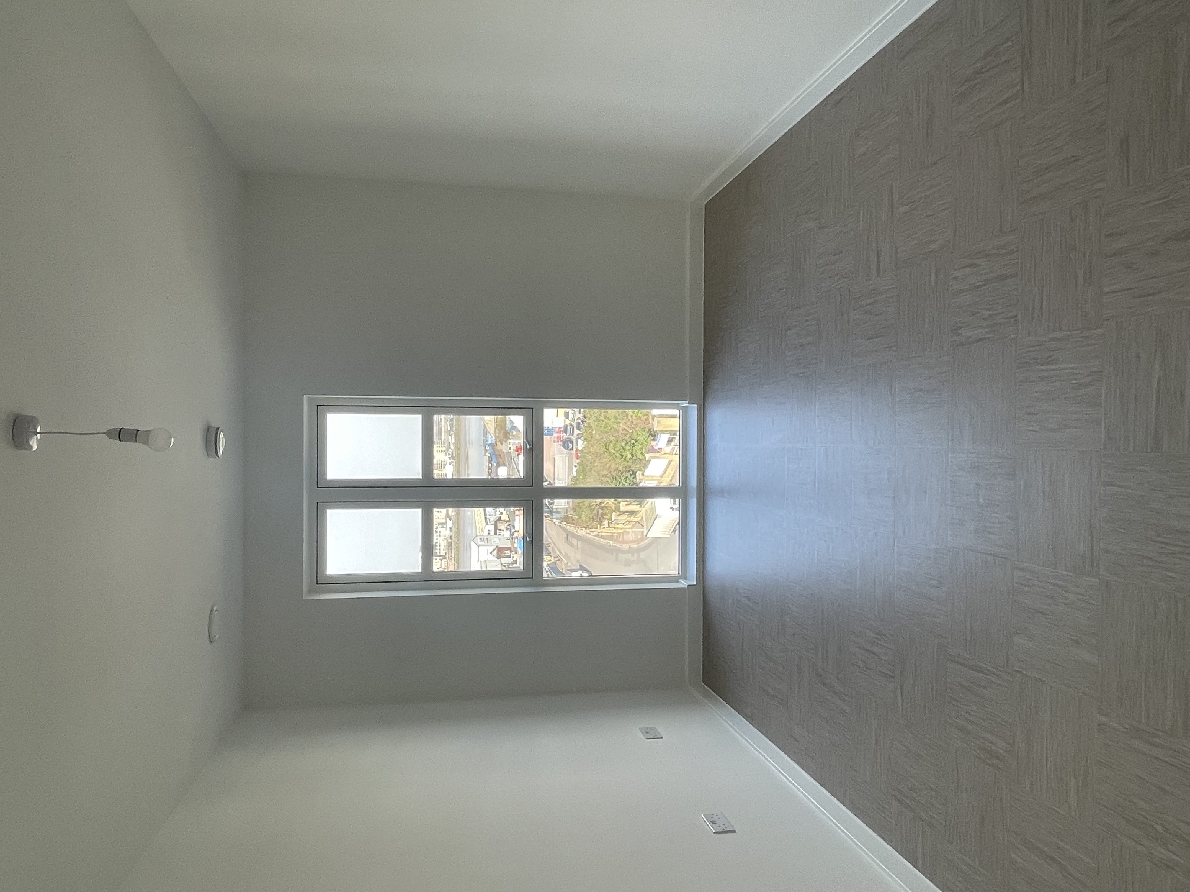 An unfurnished bedroom with windows.