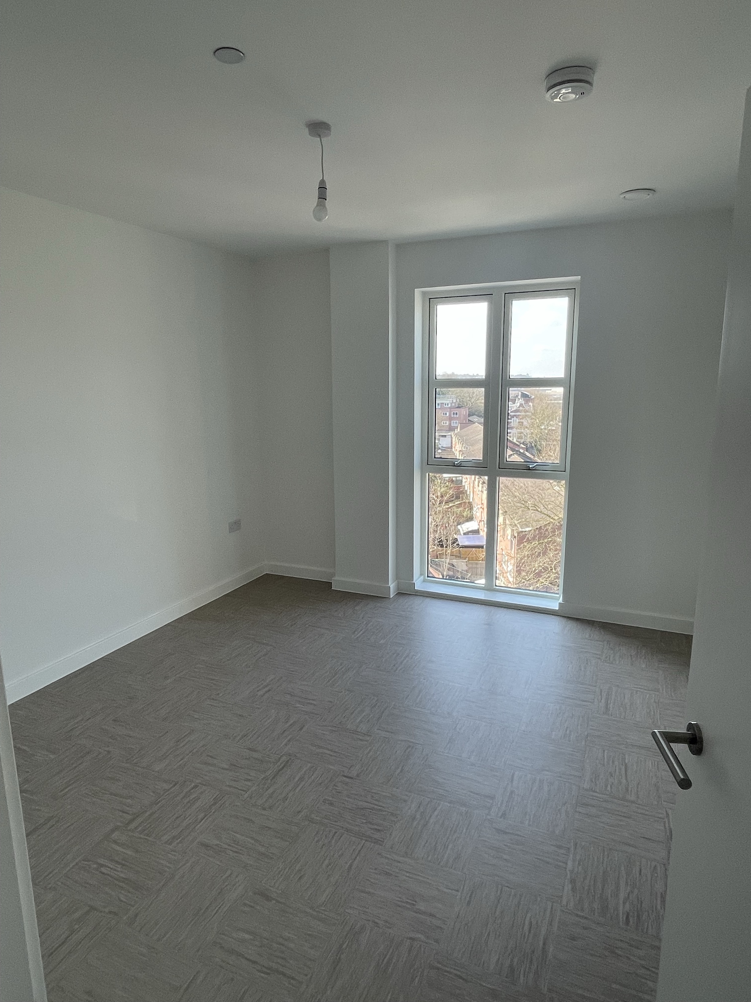 An unfurnished bedroom with windows.