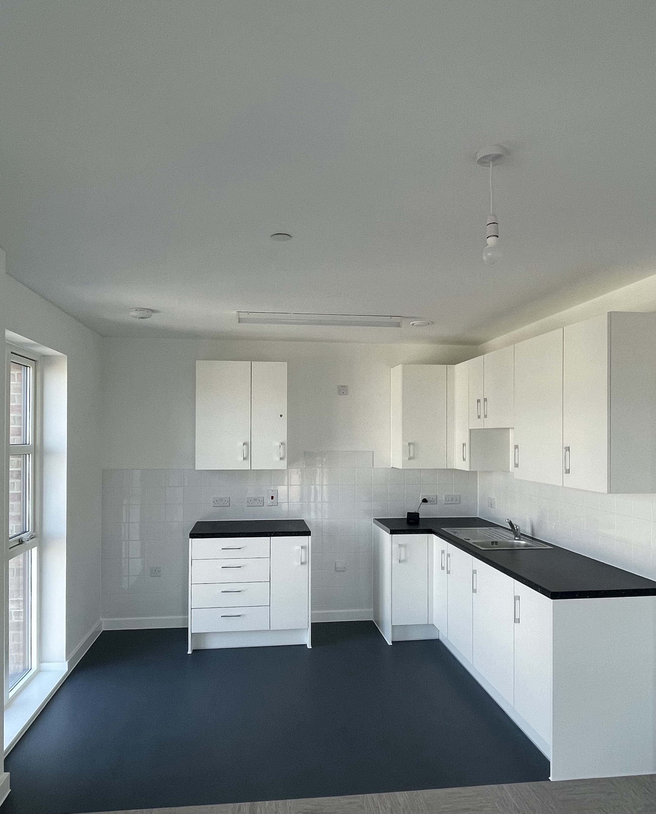A new unfurnished kitchen with cabinets.