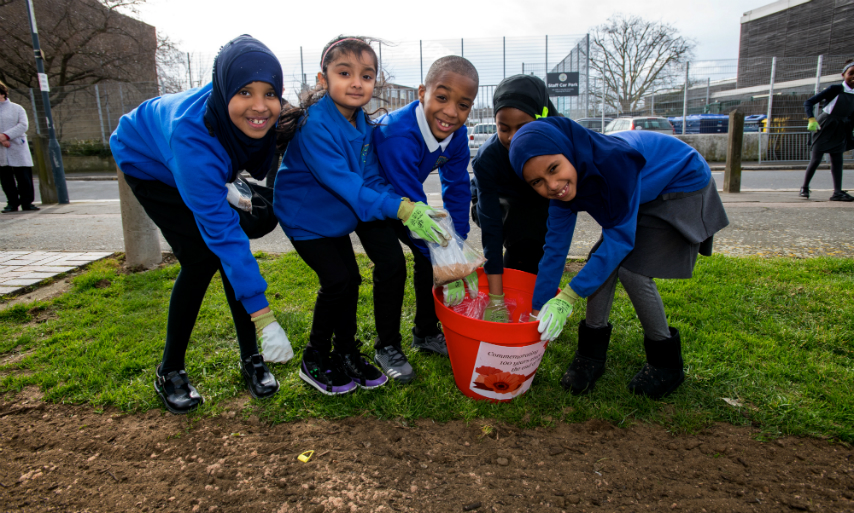 Children from Mulgrave School planting poppies earlier in the year