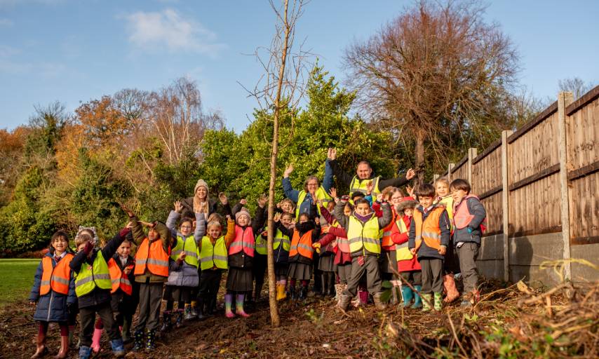 The Leader Danny Thorpe and Councillor Miranda Williams planting the 1000th tree with pupils from Christ Church Primary School