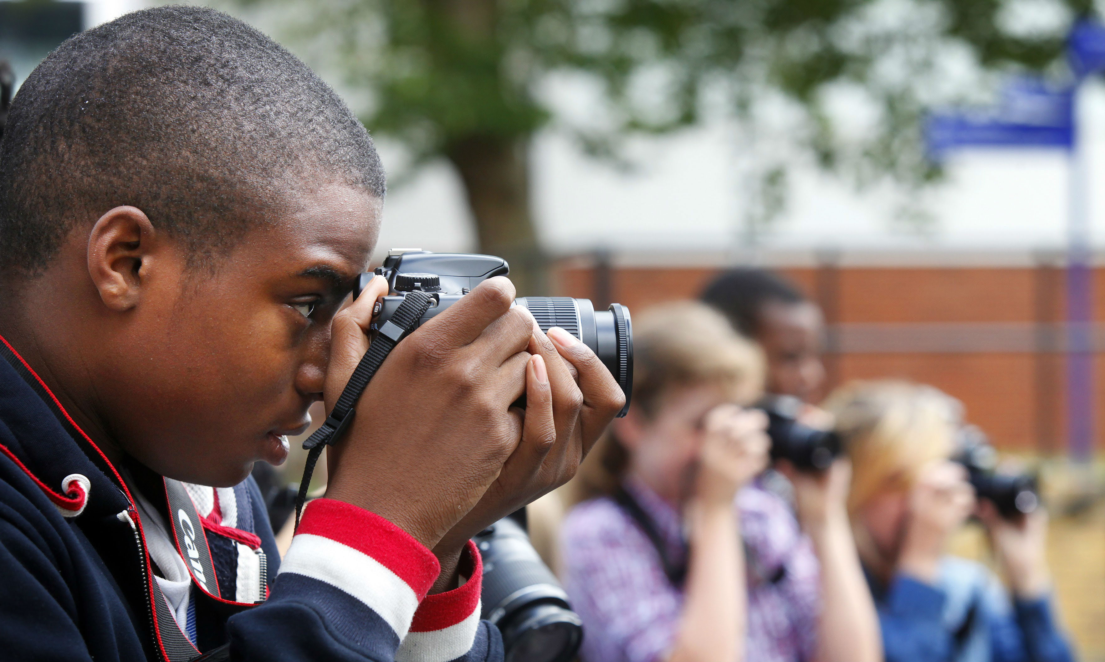 Boy taking a photograph.