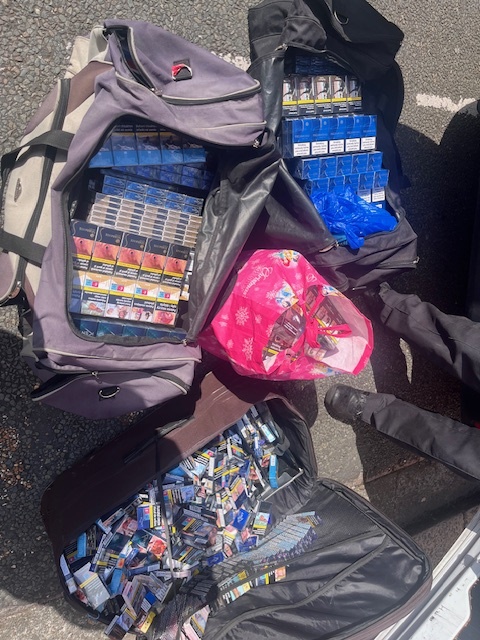 A photo of three sports bags full of illegal tobacco products