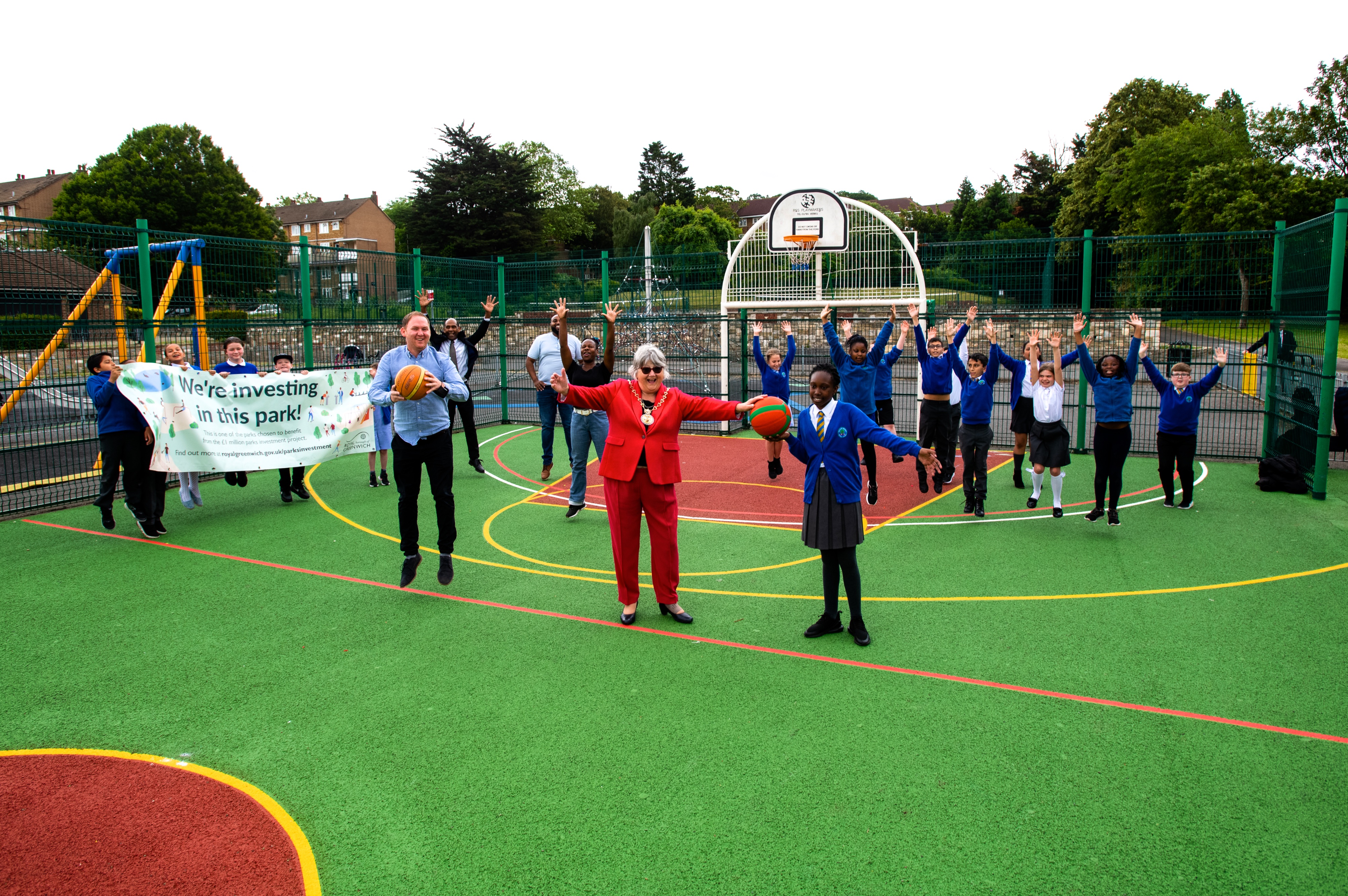 Pupils and councillors in the newly marked basketball court in bostall gardens