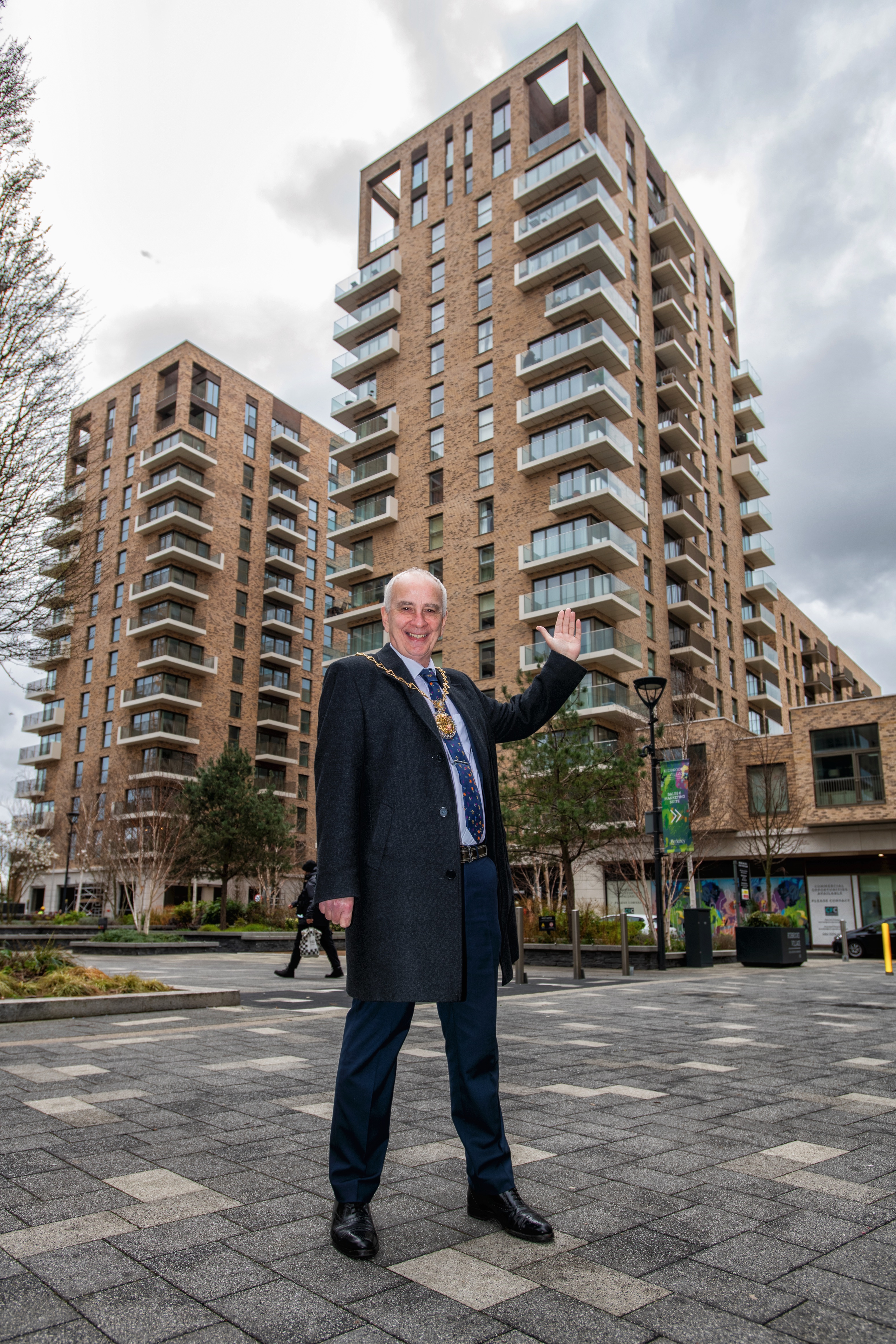 Mayor Cllr Leo Fletcher in front of a tall building in Pegler Square