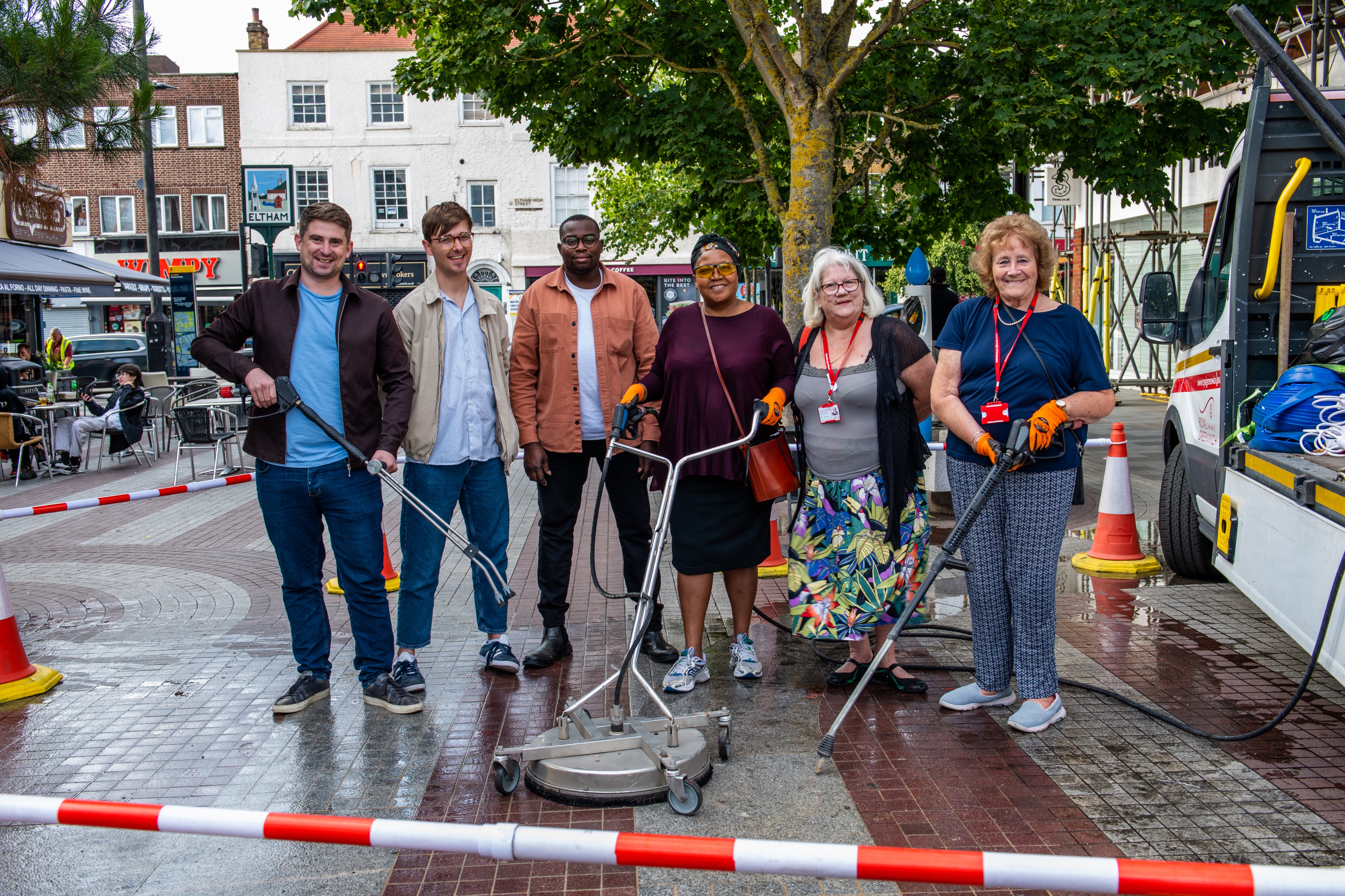 Cllrs Lloyd, Backon, Okereke, Lekau, May and Greenwell stand in Passey Place holding jet washing equipment