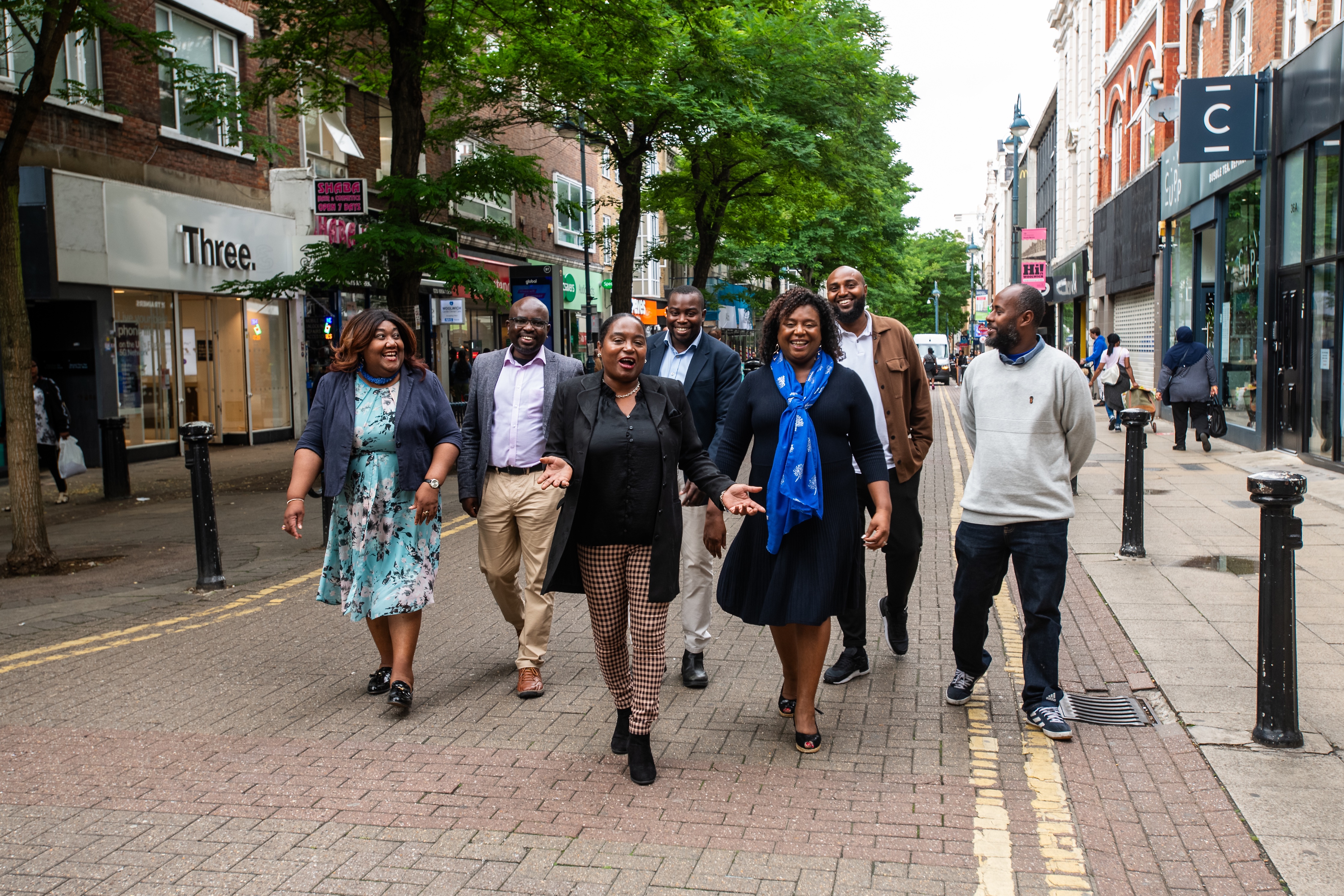 Councillors Okereke and Khaireh walking through Woolwich with community panel member Abdigani Mohamoud, Francis Akinola, Gaynor Deterville, Ruth Gabriel and panel assessor Dr. Myrtle Emmanuel