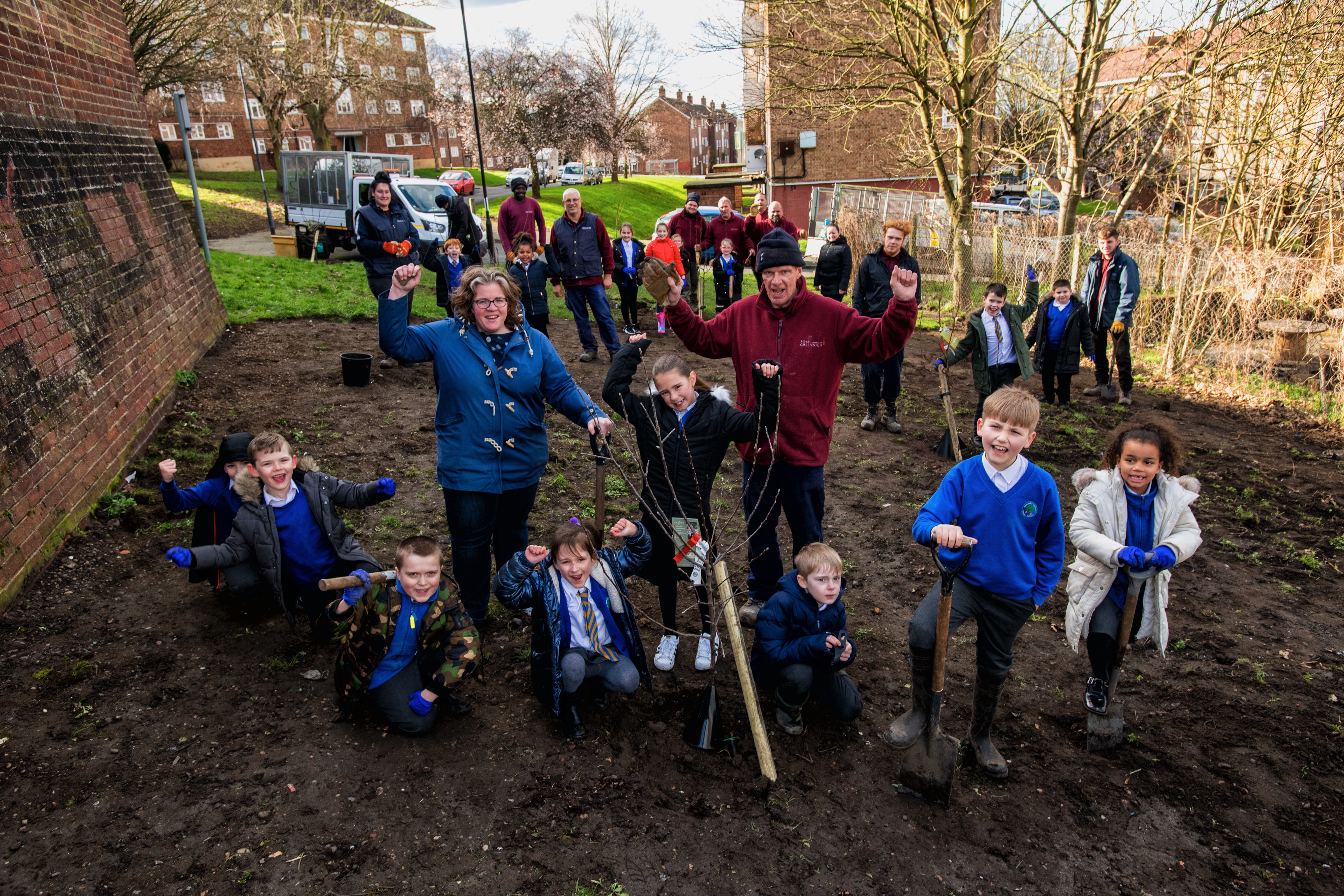 Pupils from Alex McCloud Primary and Cllr Williams celebrating the new fruit trees!