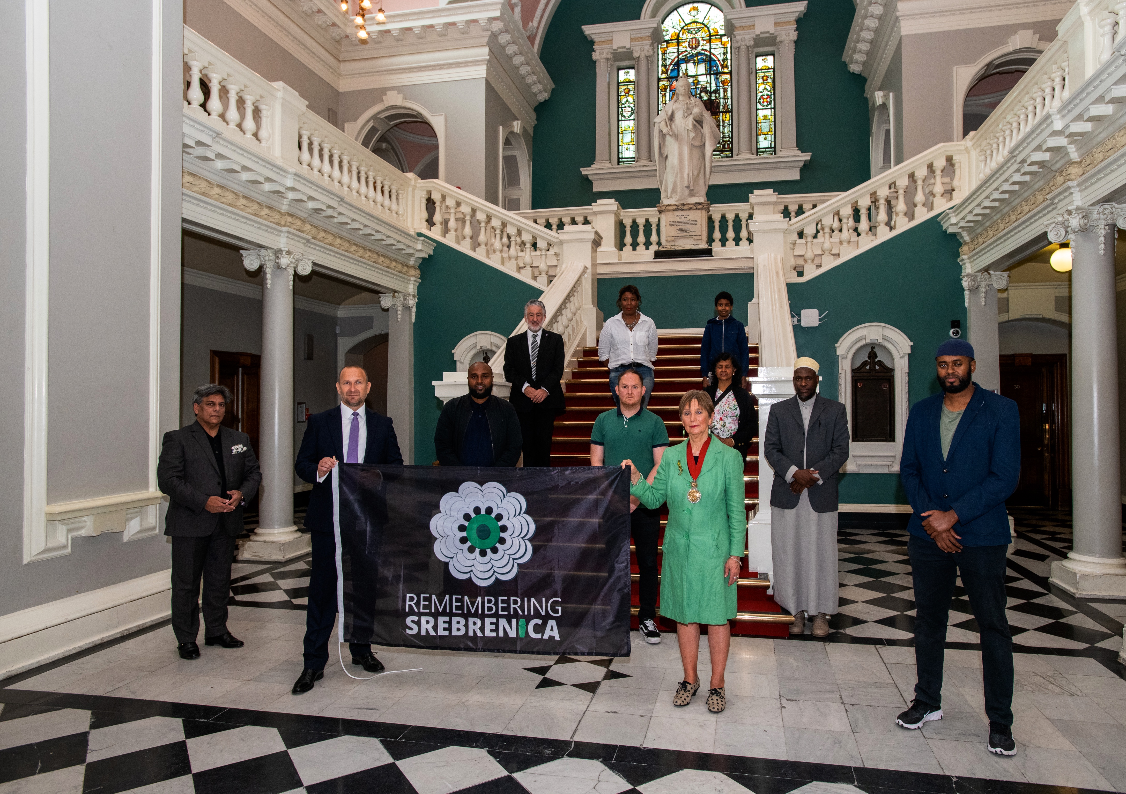 Mayor and Leader of Council with faith leaders raising flag to remember Srebrenica