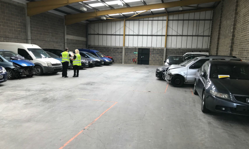 The 18 seized vehicles in a storage warehouse.