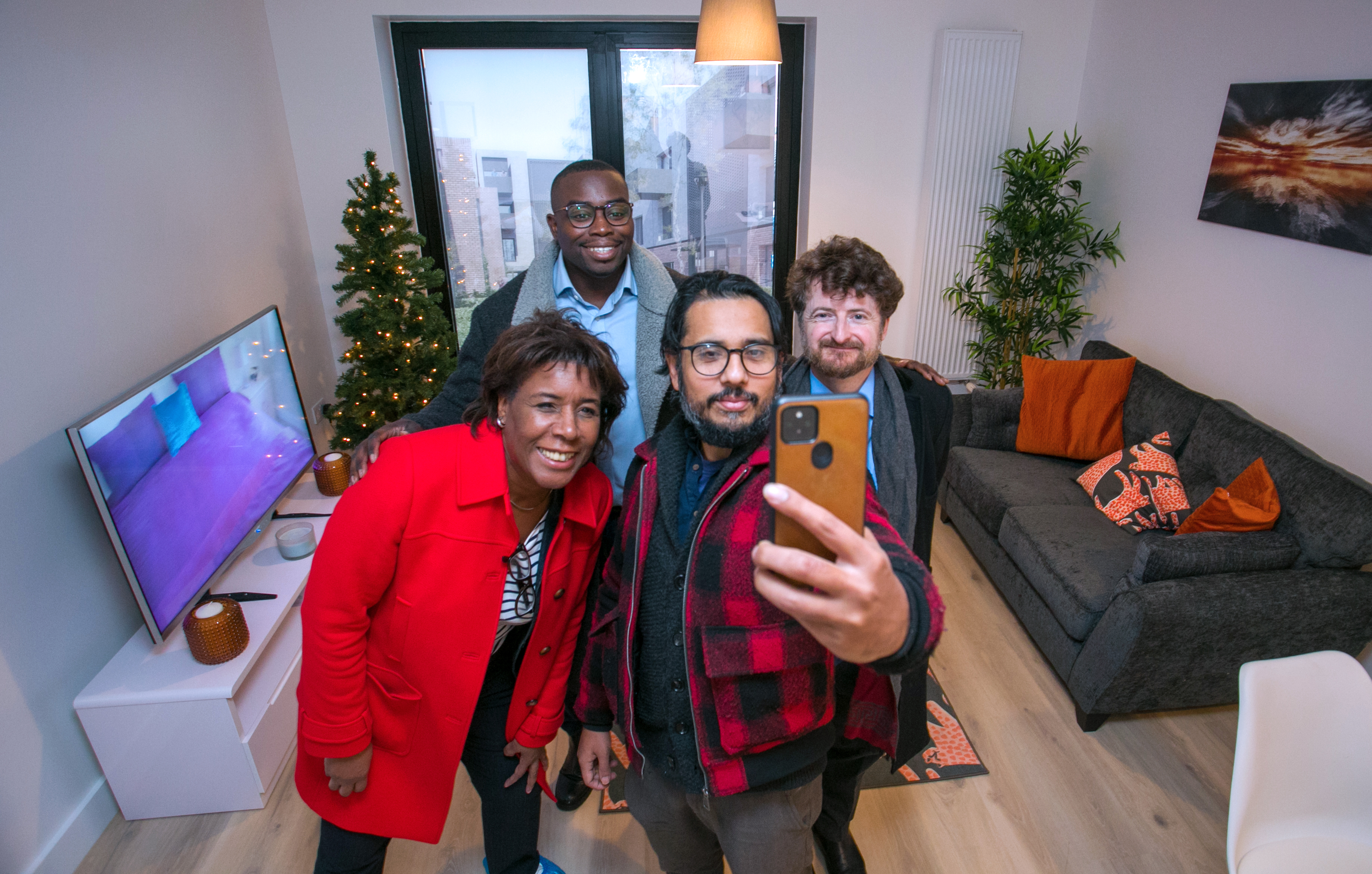 Cllr Scott-Mcdonald, Cllr Okereke, Cllr Rahman and Cllr Smith pose for a selfie inside a newly furnished living room