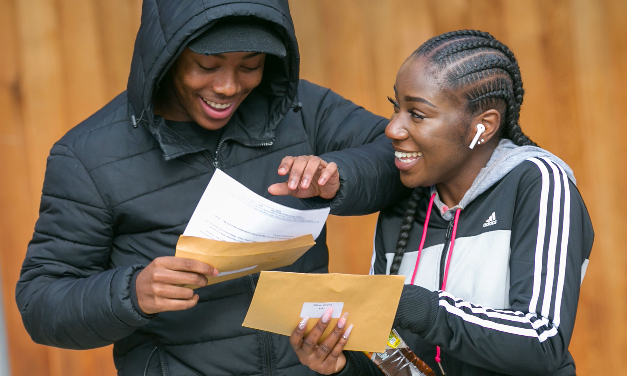 Two students opening their A-Level results.