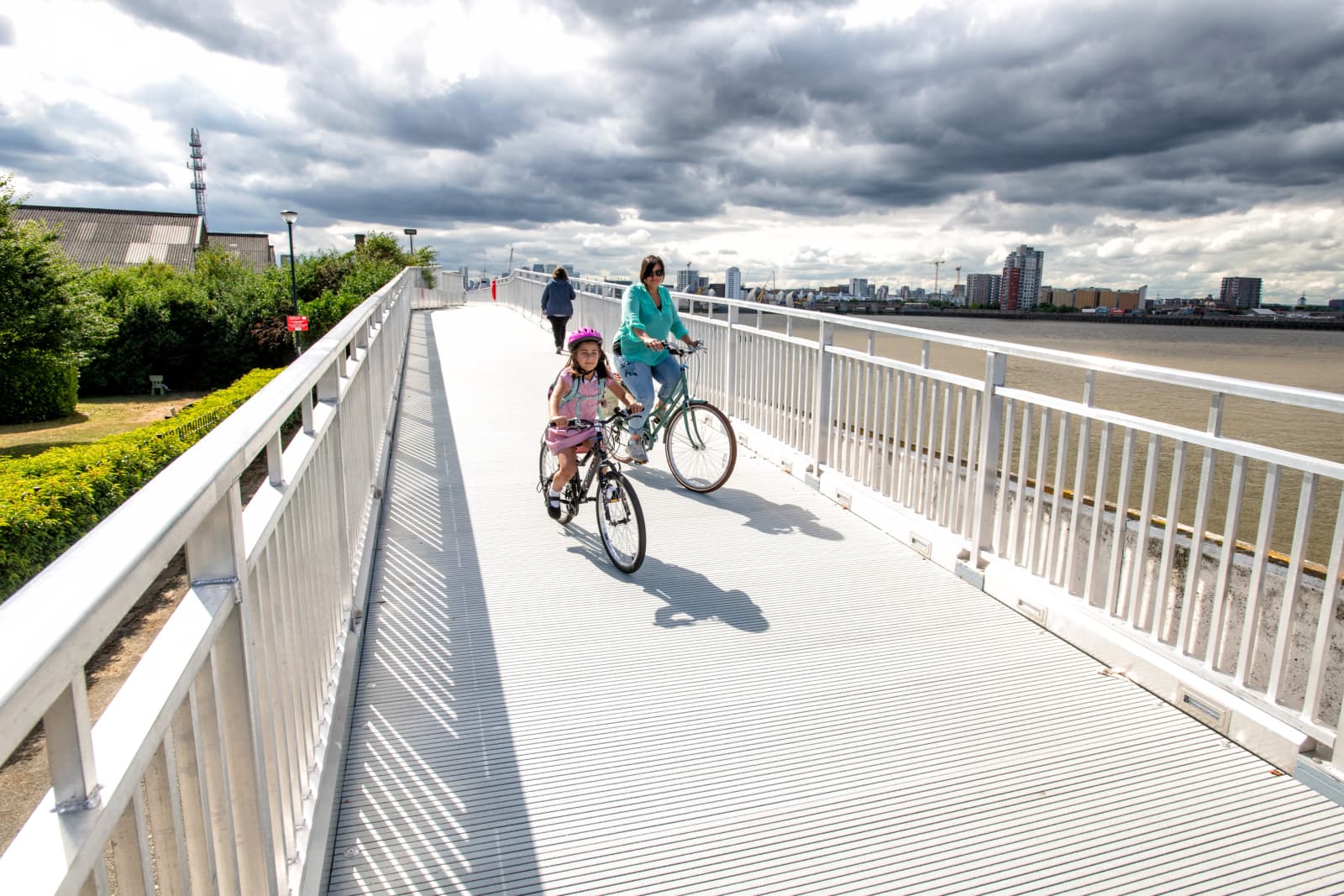 People cycling by Thames