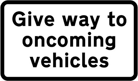 Black rectangle sign with 'give way to oncoming vehicles' on it in black font