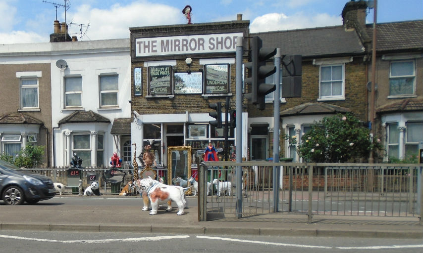 Items like full length mirrors, large animal sculptures and superhero figurines on display outside the Mirror Shop on Woolwich Road