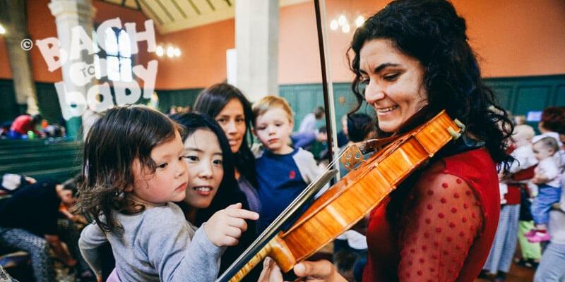 Bach to Baby event, a child taking an interest in a violin