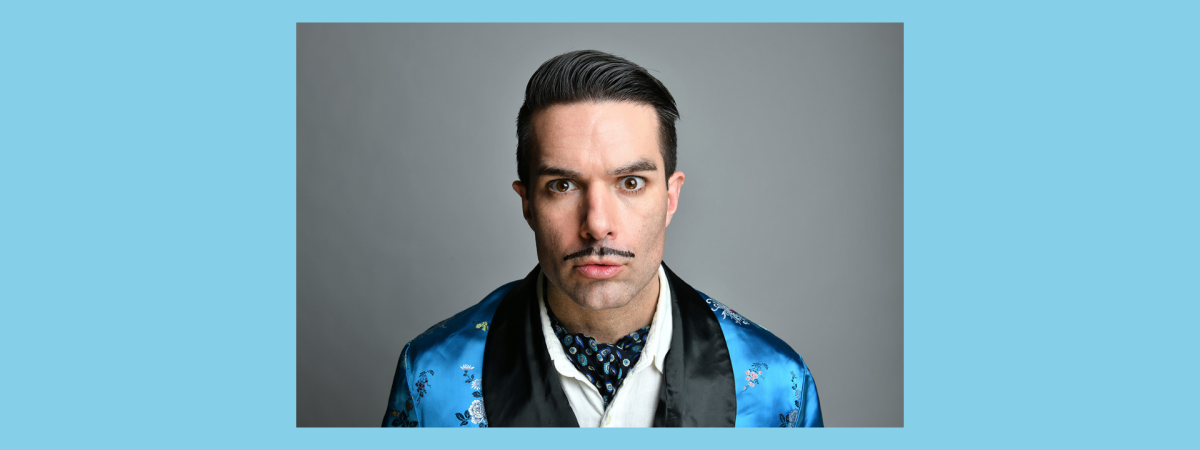 A close up of person's face, who has short hair and a moustache (Troy Hawke)