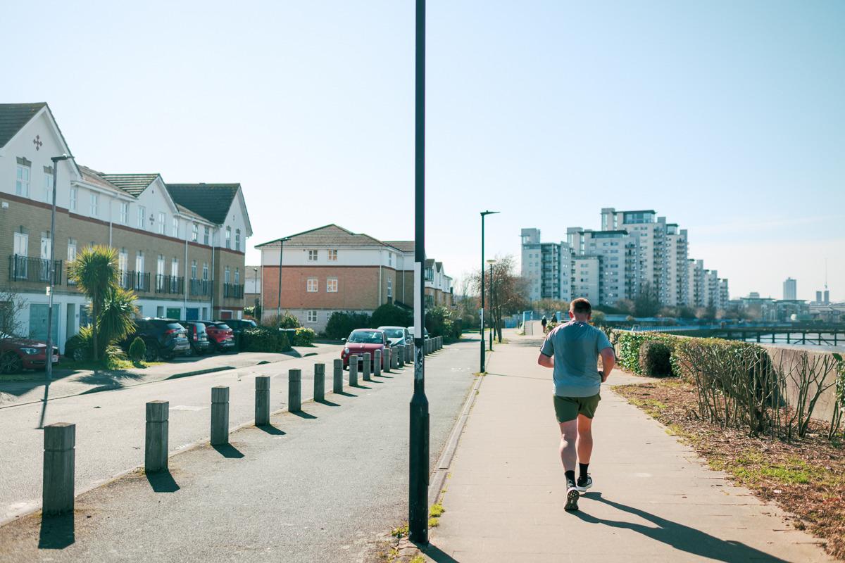 Person running along Thames Path.