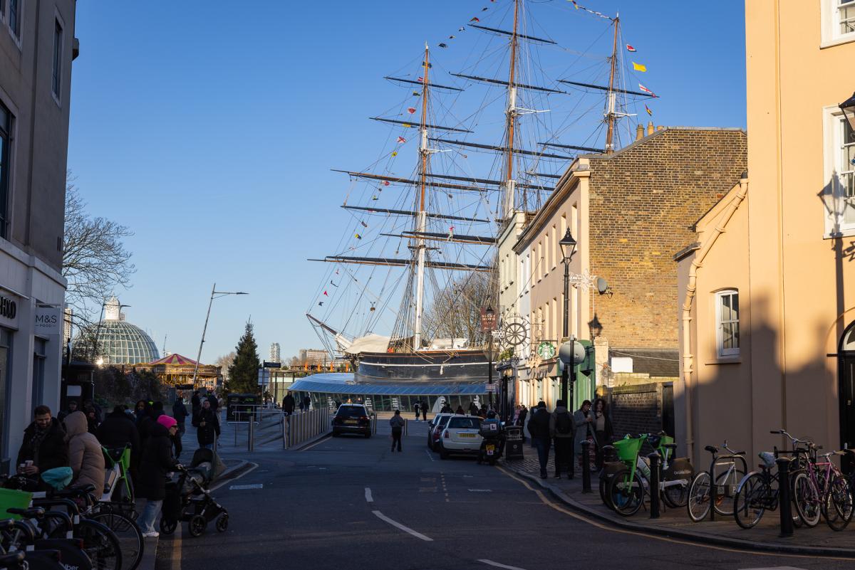 A photograph of Greenwich Town Centre with the Cutty Sark in the middle distance