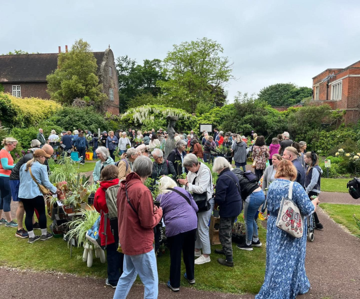 A group of people at a plant fair in the gardens at Charlton House