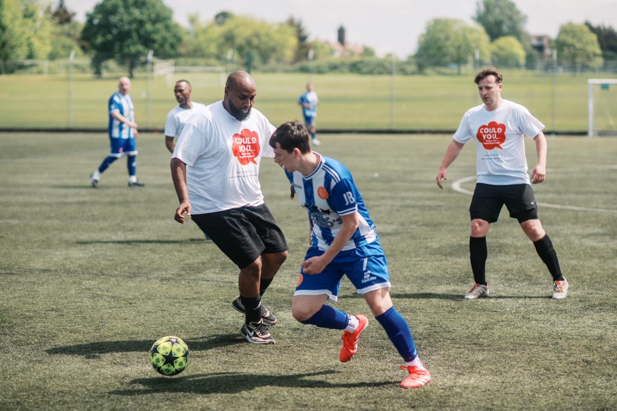 Cllr Adel Khaireh playing football.
