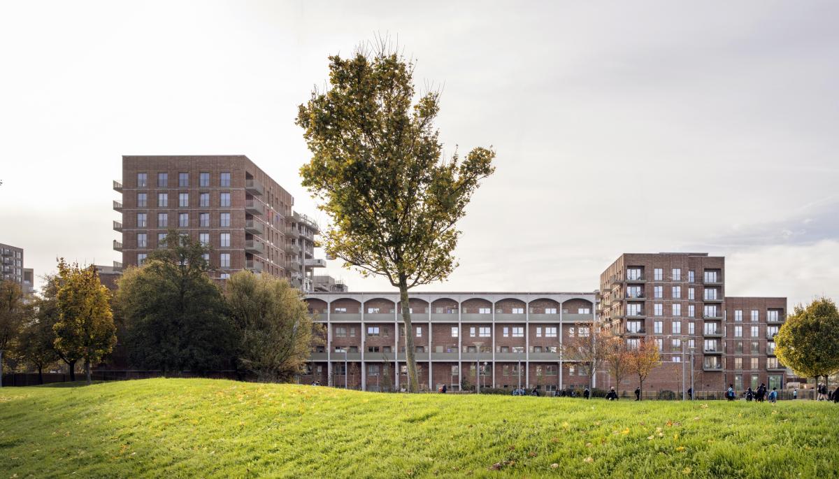 A photograph of the new 122-home development with greenery in the foreground