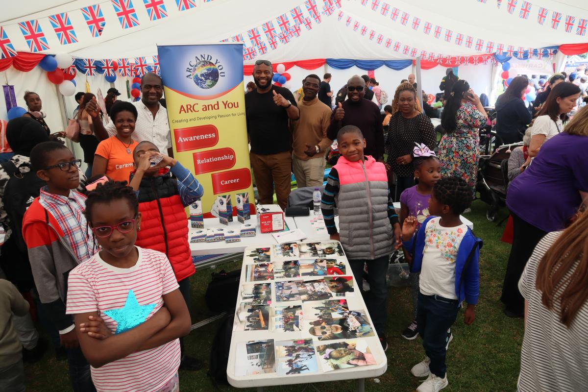 A group of people inside a marquee at an event.