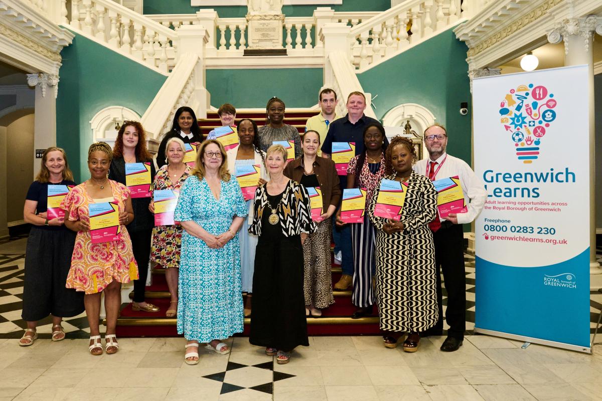 The winners of the Adult Community Learning Awards hold up their certificates on the steps inside the Town Hall with Cllr Jackie Smith and Cllr Linda Bird 