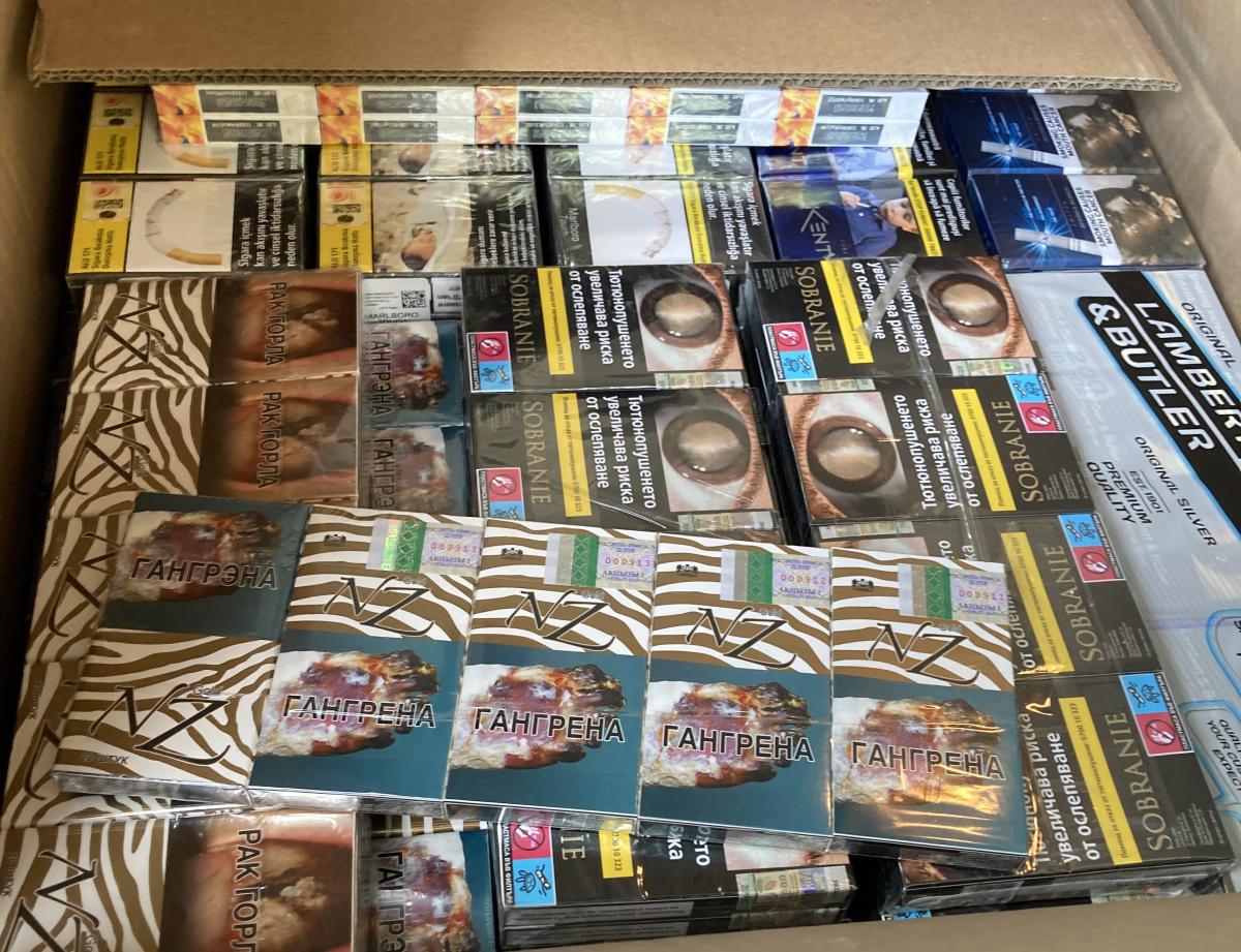 A box full of packets of seized cigarettes 
