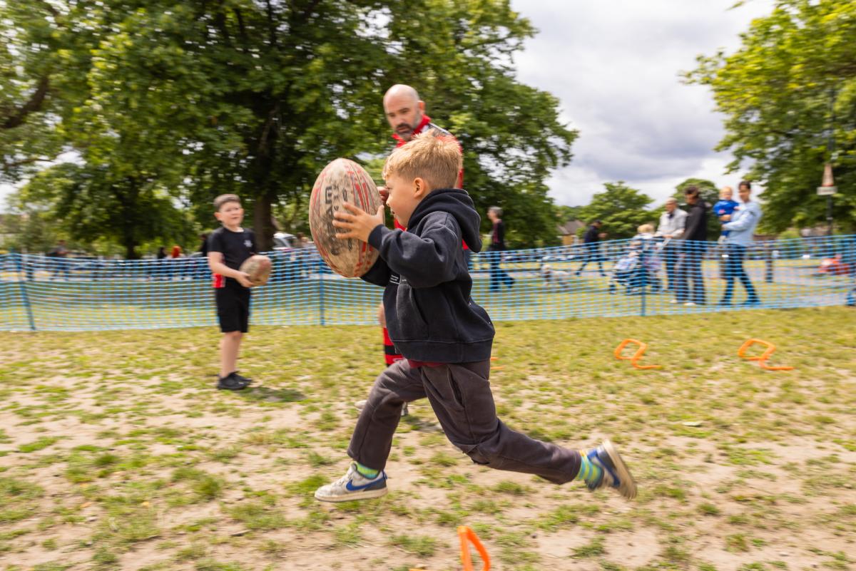 Child playing rugby at Plumstead Make Merry