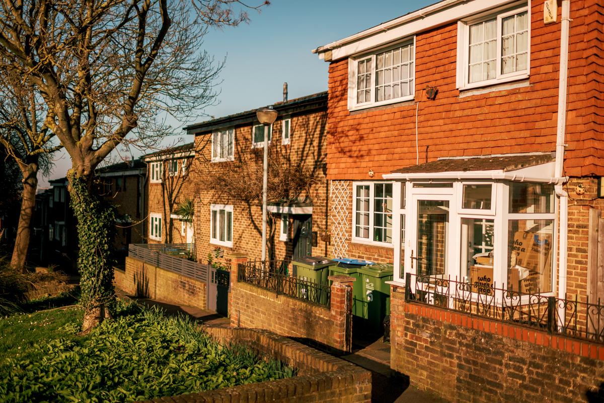A row of brick houses, with grass in front of them