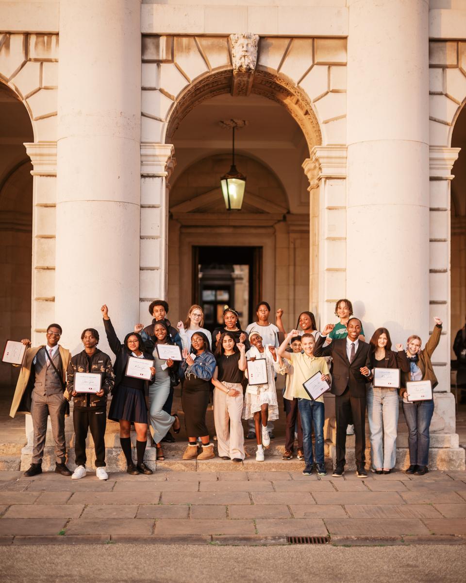 A diverse group of students in celebrating their achievements within Greenwich Young People's Council.