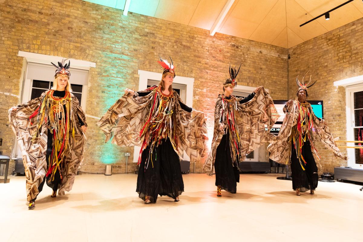 Four dancers on stilts