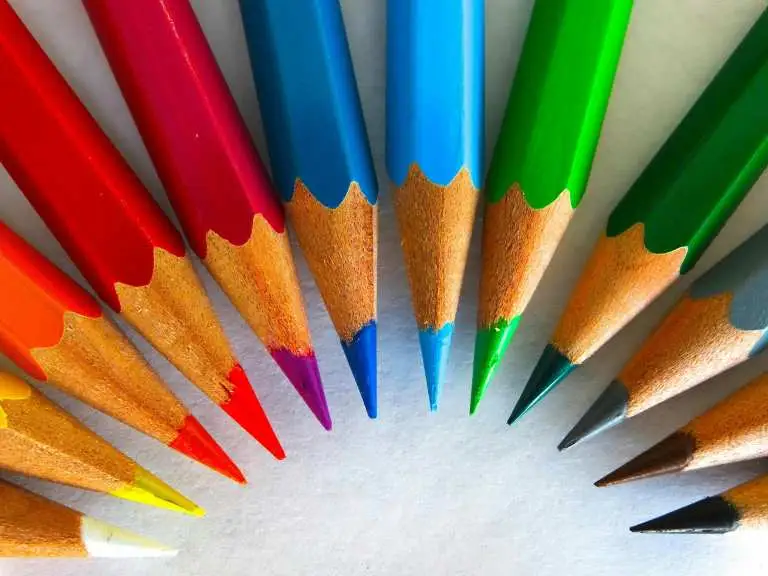 A rainbow of colourful pencils in a curve.