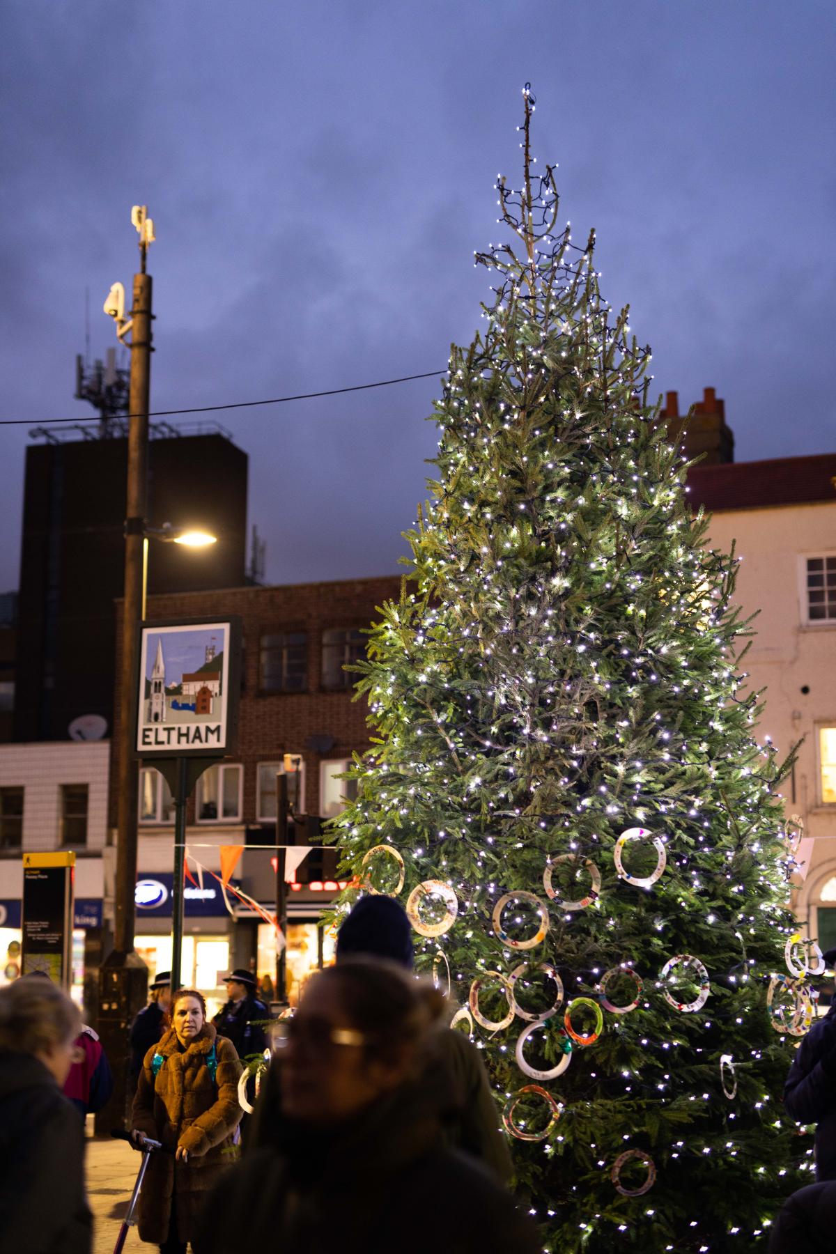 A Christmas tree next to 'Eltham' sign