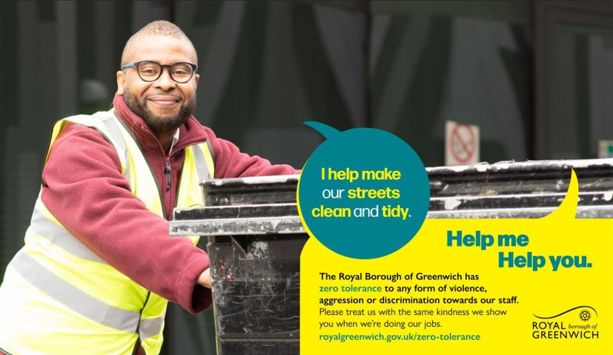 Man wearing a hi vis pushing  a bin.