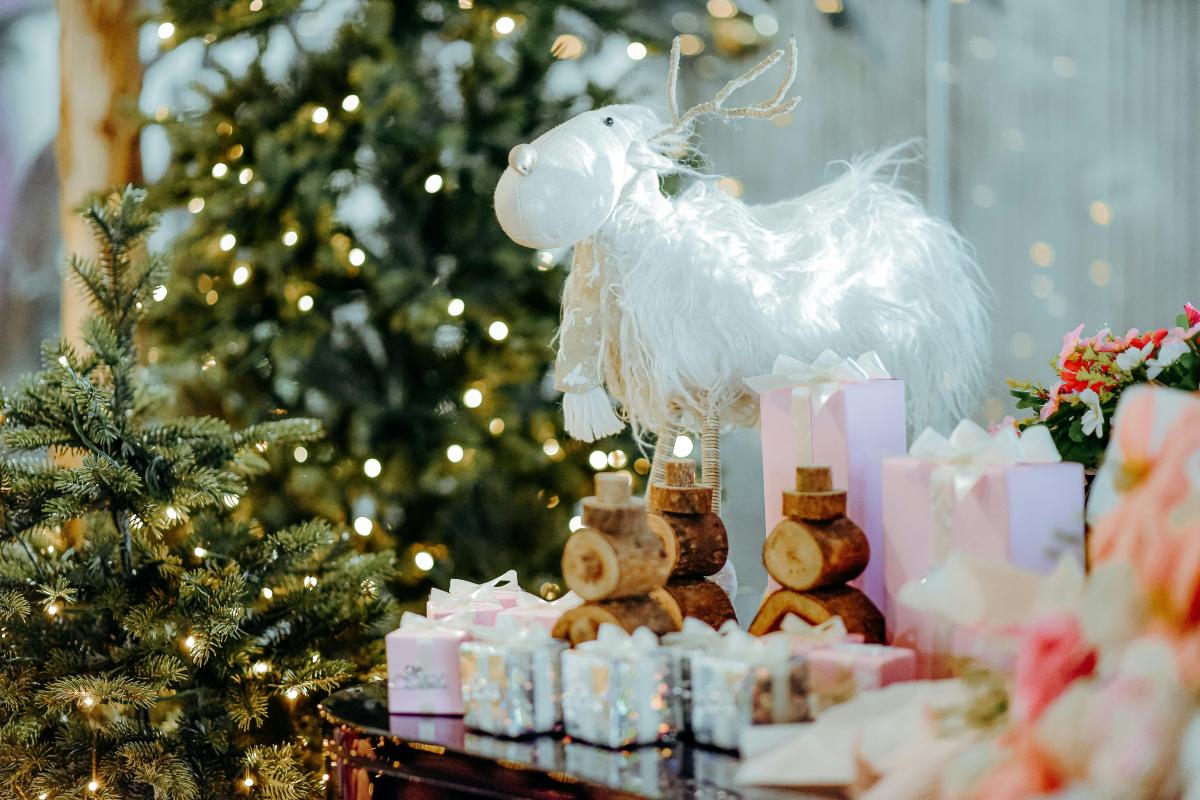 christmas tree with decoration with a table next to it with present on it