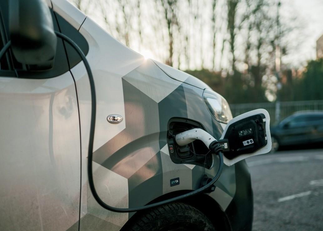an electric white van being charged